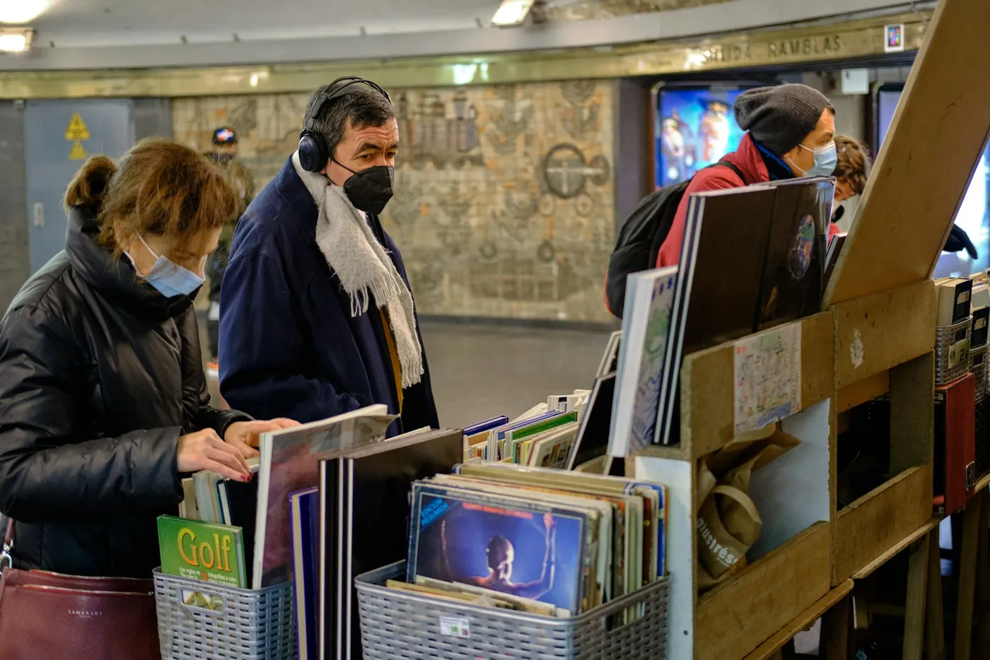 People browsing a bookshop inside Catalunya metro station in Barcelona, Spain