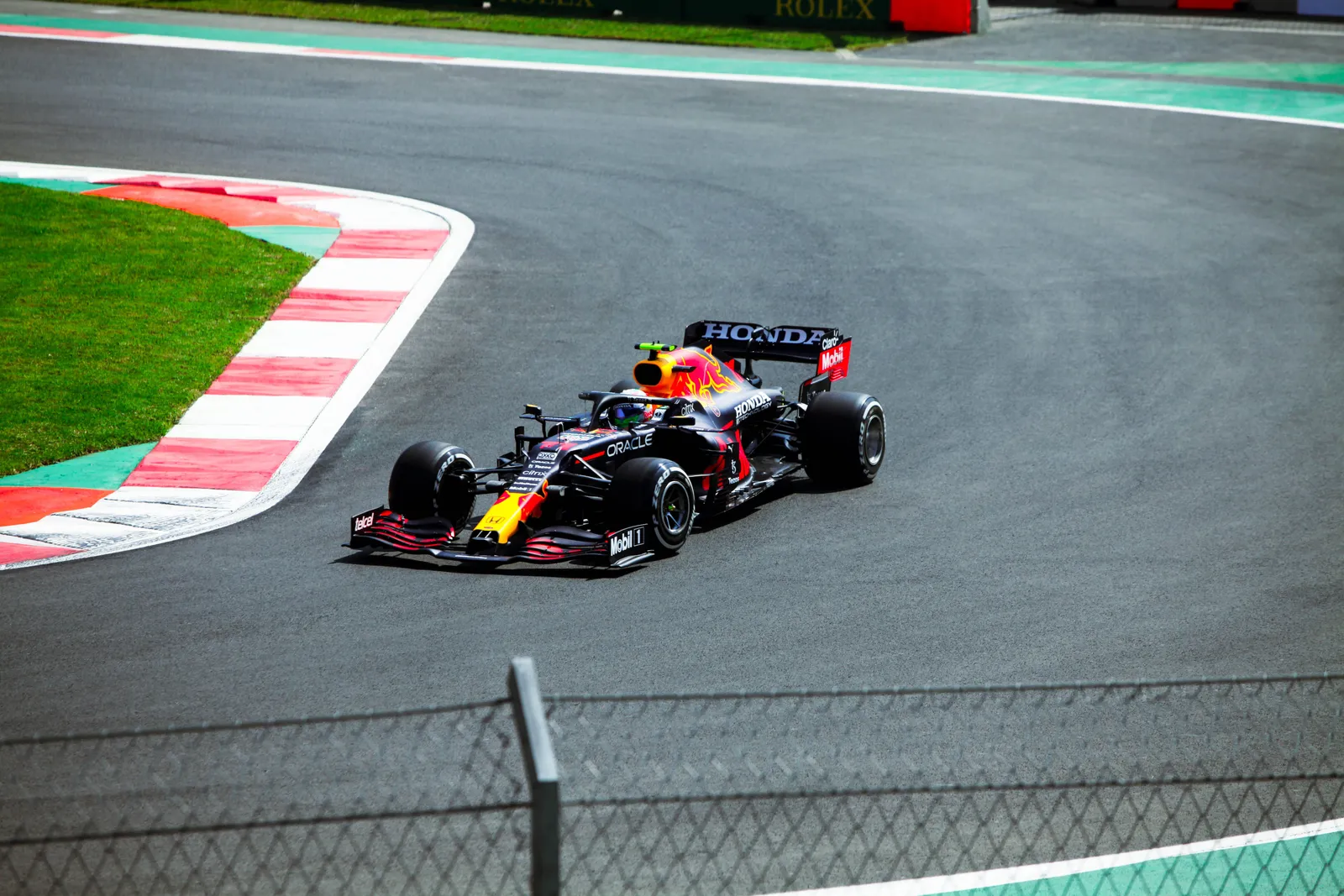 A Formula 1 car cornering on a race circuit during a daytime session