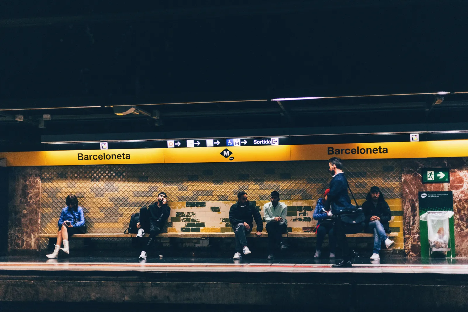 A Barcelona metro entrance on a city street in daylight