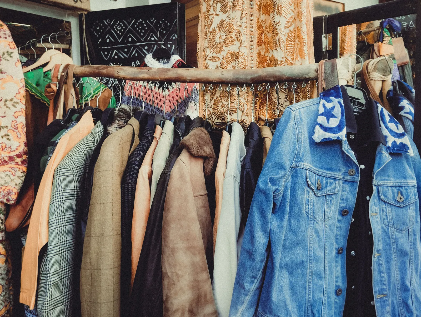 A rail of vintage clothing outside a second-hand shop on a narrow street in the Raval district of Barcelona