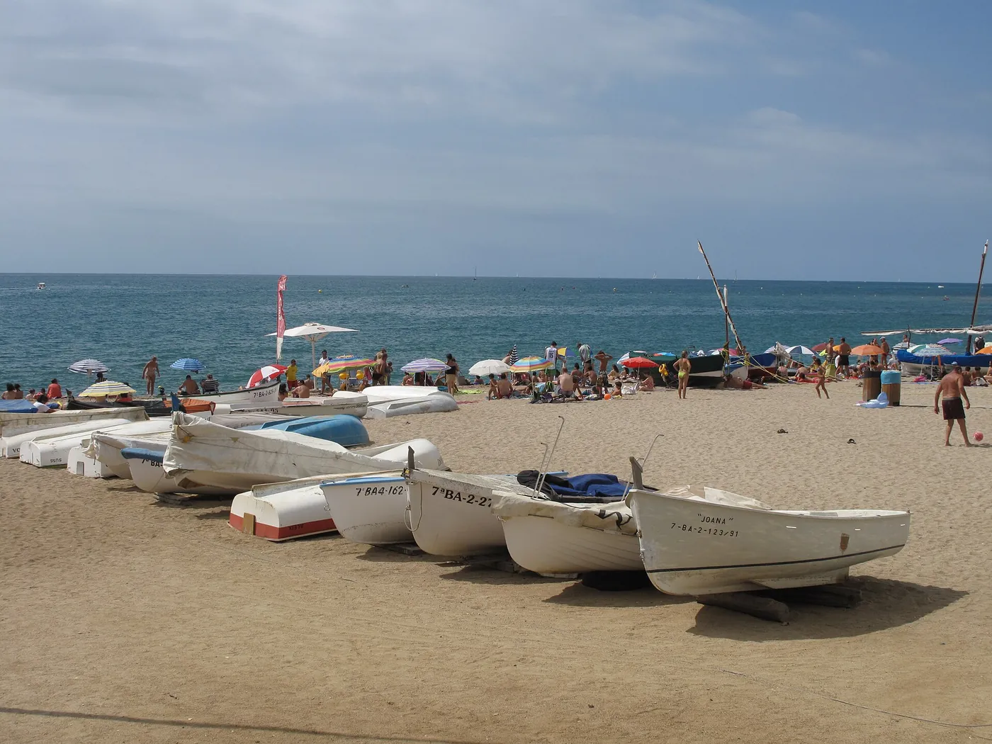 Fishing boats pulled up on the beach at Sant Pol de Mar on the Catalan coast, in daylight
