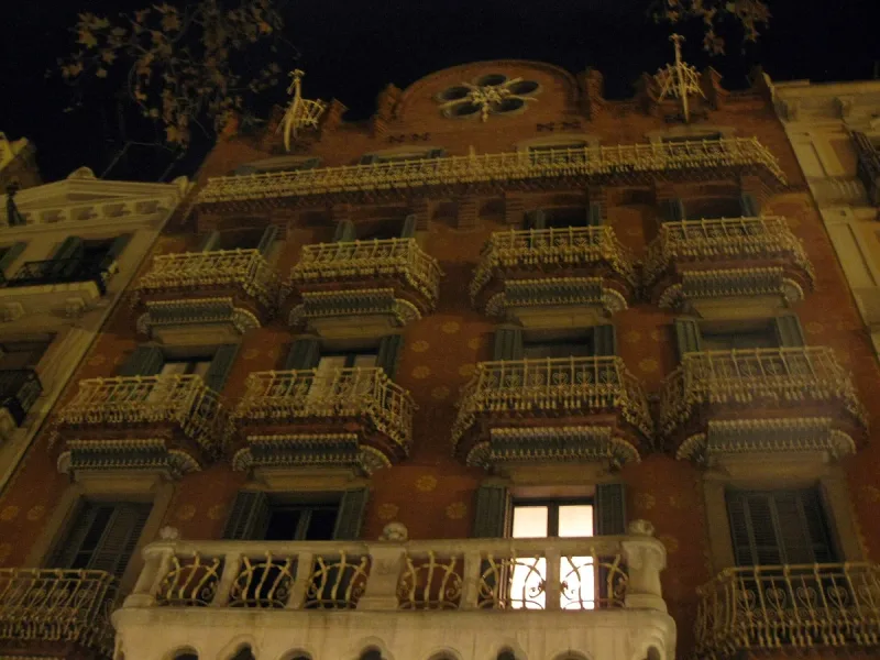 Ornate modernist building facade with carved stone balconies on the avenue