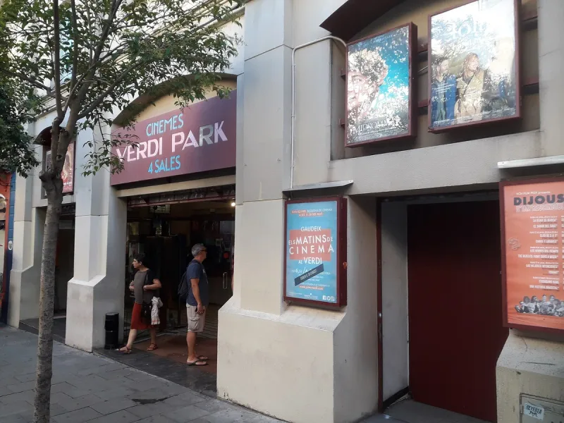 Cinema frontage with a Verdi Park sign and lit film posters