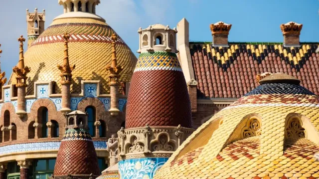 Domes and tiled roofs in colorful patterns, with ceramic clad turrets among them