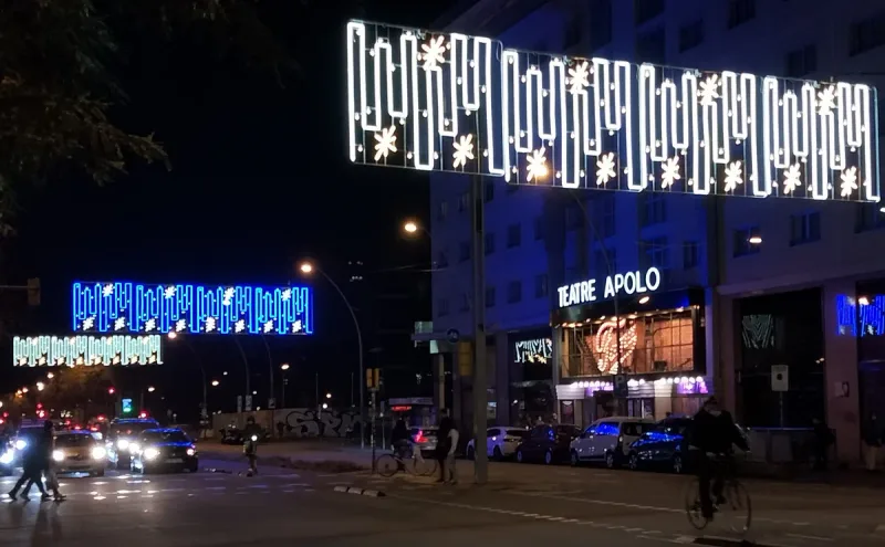 Evening avenue with the neon sign of the Apolo theatre and street lights